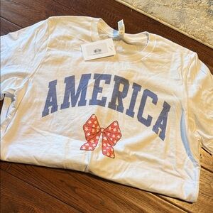 Bella Canvas White Tee with Blue 'America' and Red Bow